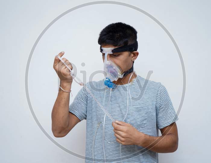 Young Handsome Asian Teen Boy Wearing An Oxygen Mask, Stop Corona Virus And Stop Pollution Concept.