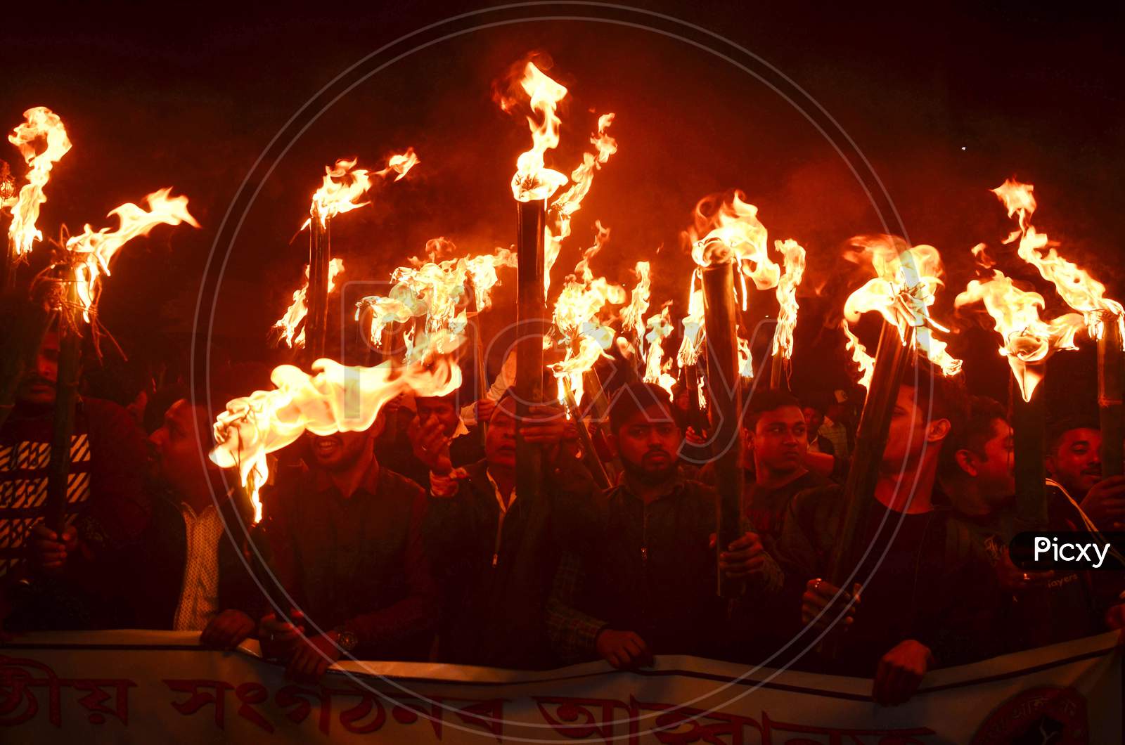 Activists of All Assam Students Union (AASU) along with 30 indigenous organizations take out a torch light procession