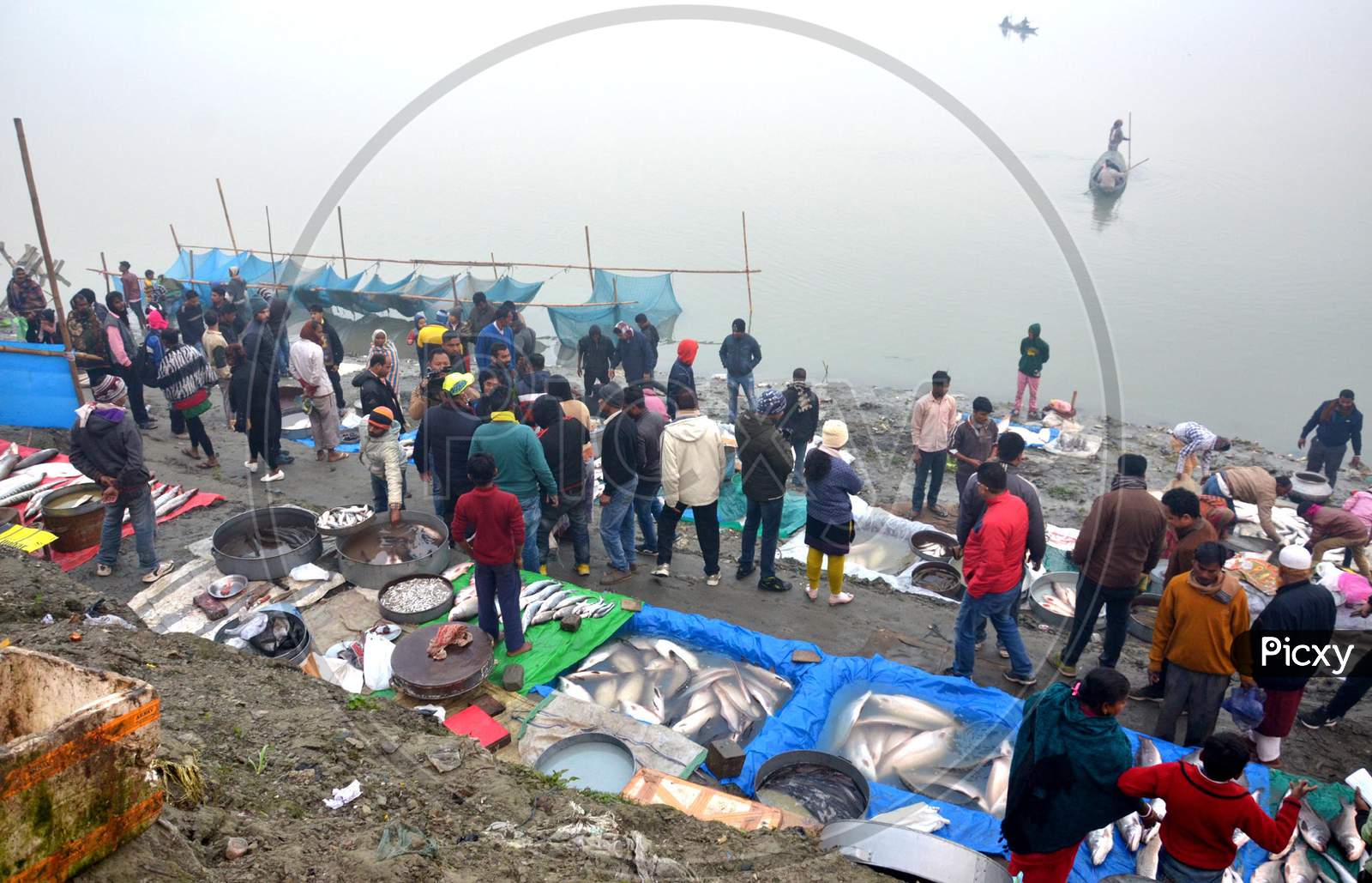 People throng in Fish Market on the bank of river Brahmaputra to buy fishes