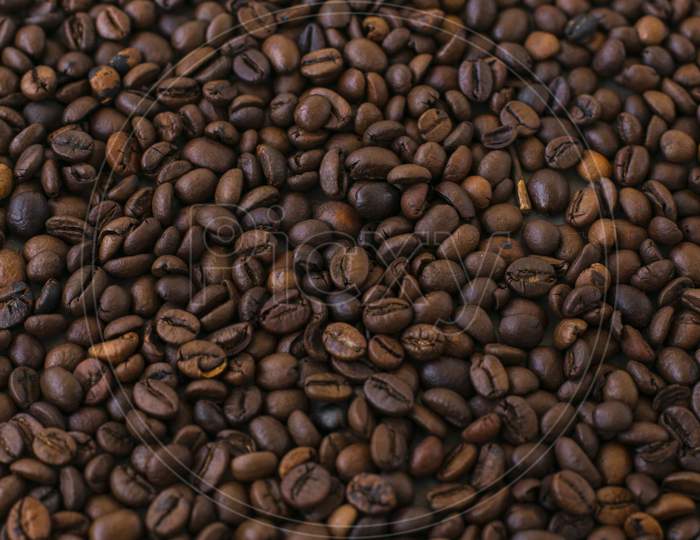 A table full of roasted brown jamaican blue mountain coffee beans.
