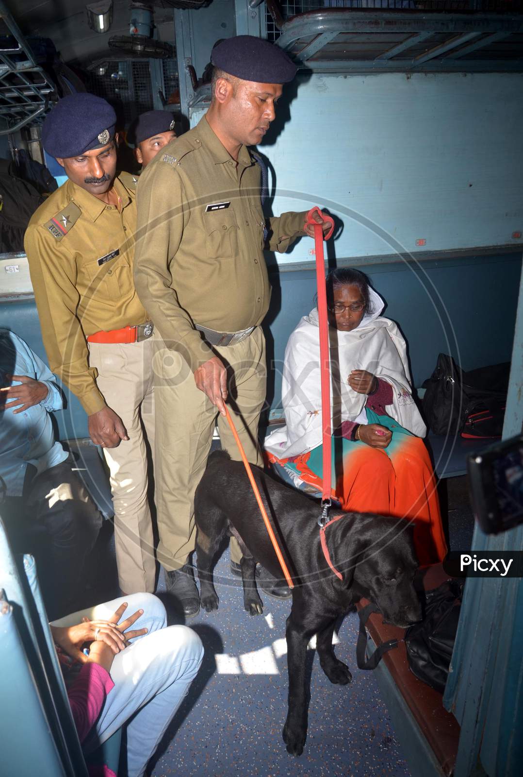 Railway Police Force (RPF) personnel inspect the tracks along with a sniffer dog,