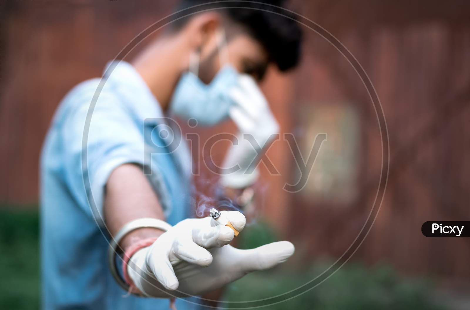 Man Holding Cigarette On His Hand And Feeling Guilty In Pandemic Situation.