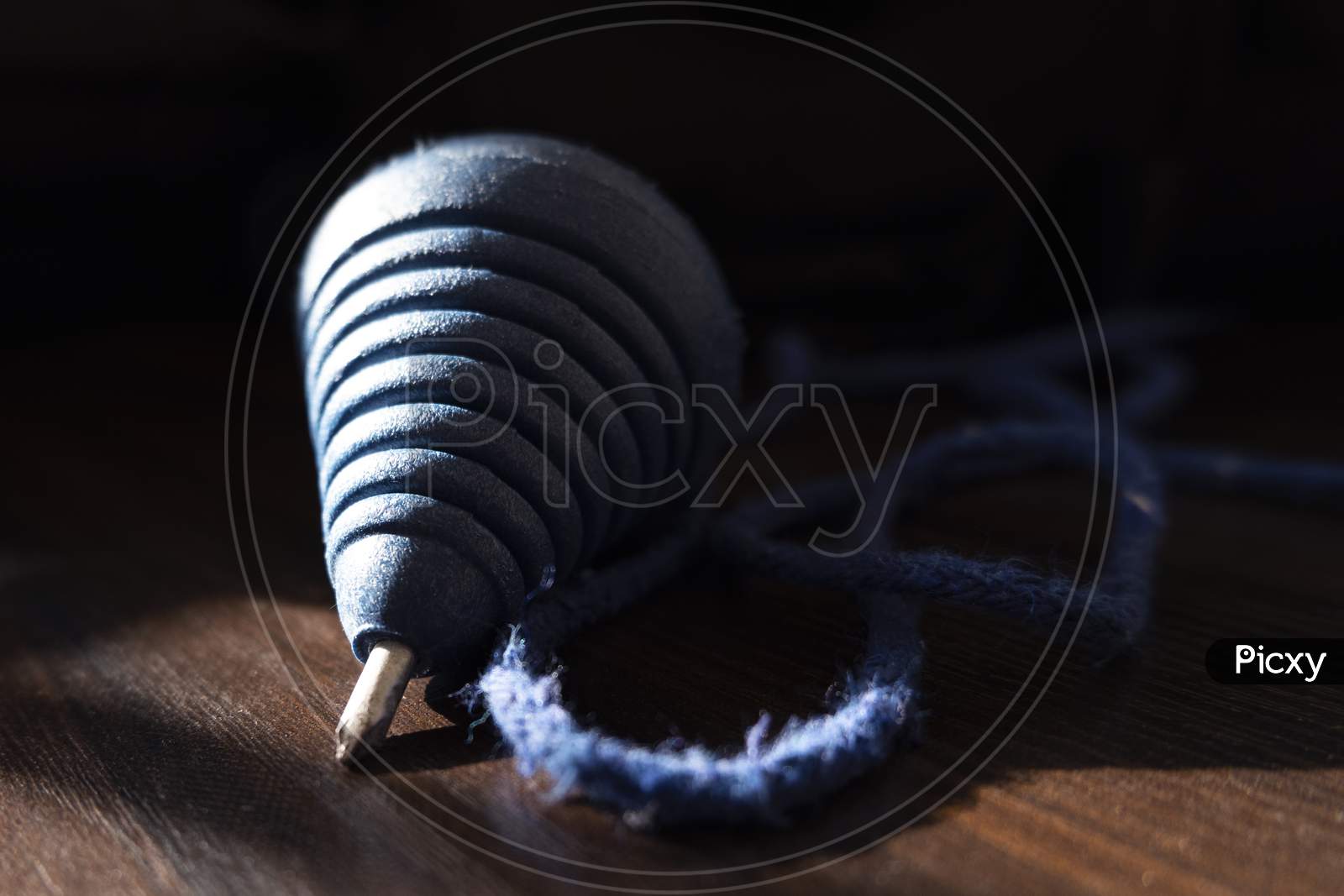 Blue Color Plastic Spinning Top Isolated On Wooden Background
