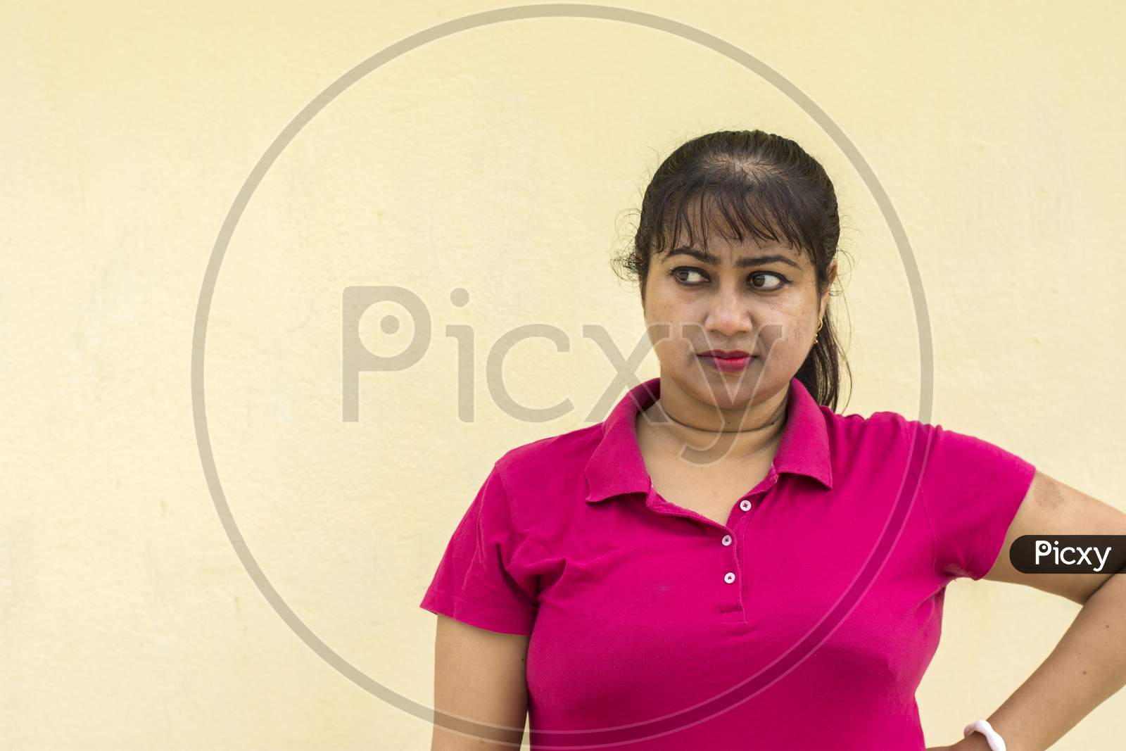 Indian Female Model Looking Right Side Angry Face In Yellow Background With Copy Space For Text