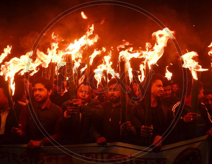 Activists of All Assam Students Union (AASU) along with 30 indigenous organizations take out a torch light procession