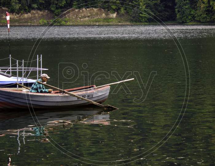 Roznow, Poland - September 04, 2014: A Man Fishing On A Parked Boat In Roznowskie Lake