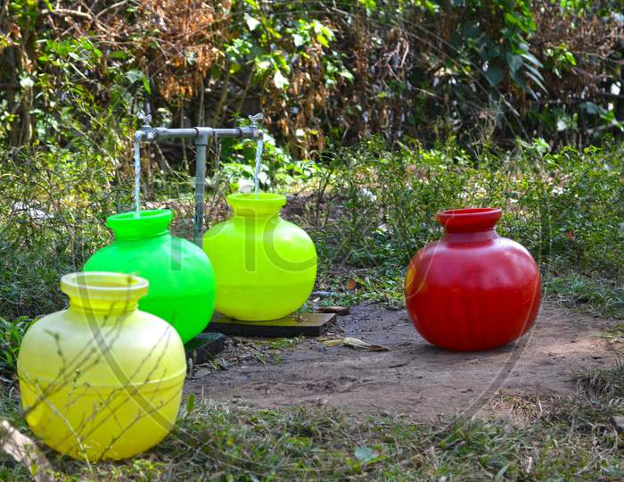 Colorful artificial pots used by village people to store water
