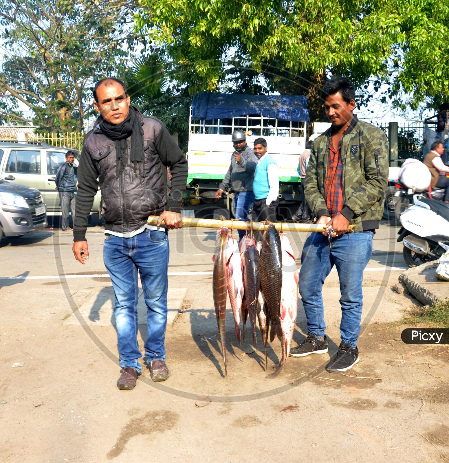 People buying different types of fishes at a local fish market on the occasion of Magh Bihu