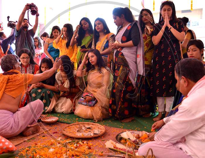 Girls offering prayers during Saraswati Puja