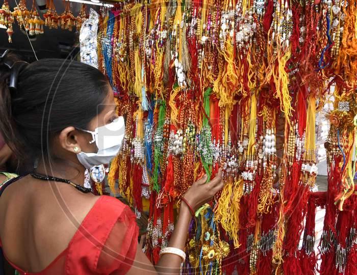 A woman purchases 'Rakhi' ahead of Raksha Bandhan festival in Guwahati on July 30, 2020.