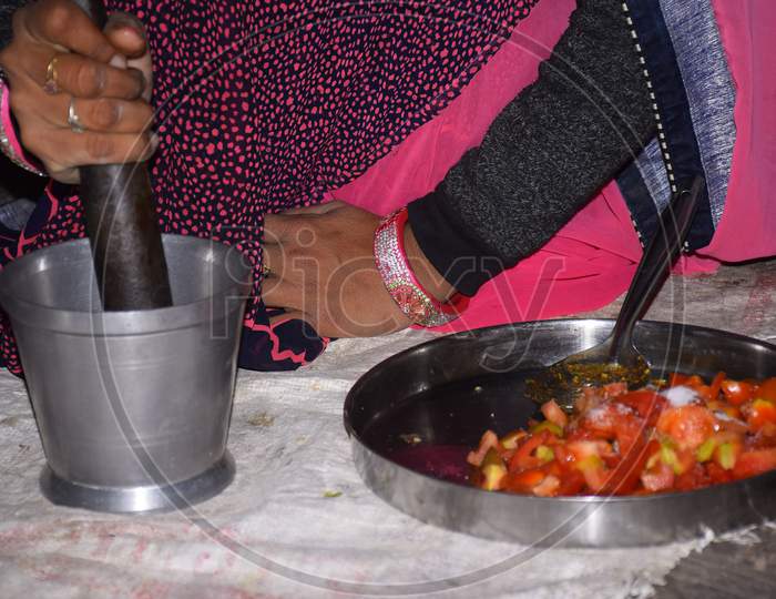 Indian Rural Woman Is Grinding Spices To Make Vegetable.