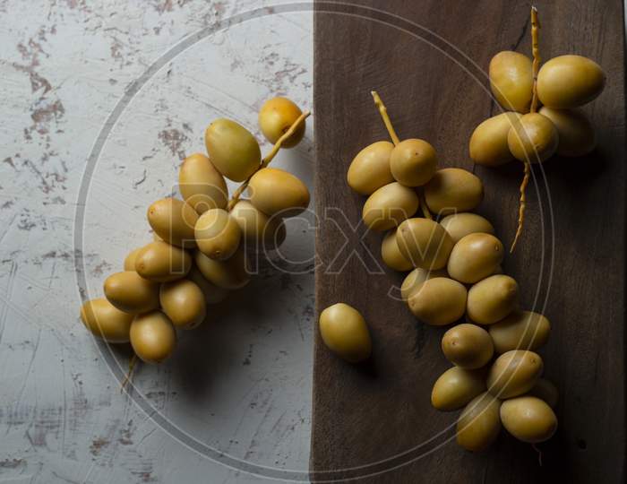 Fresh Yellow Dates On Wooden Background