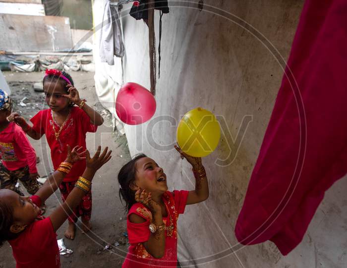 Rohingya refugee children play as they wear new clothes and make up during Eid Al-Adha (Feast of Sacrifice) festival at a camp in the outskirts of New Delhi, India on August 1, 2020.