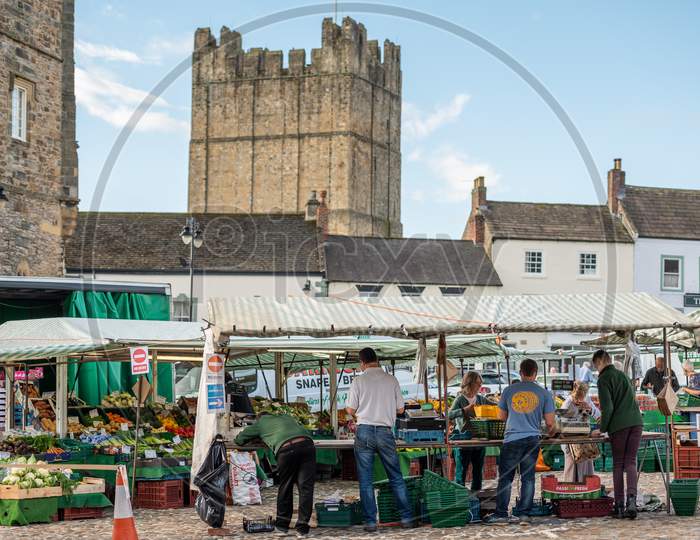 An Outdoor Market With Richmond Castle In The Background