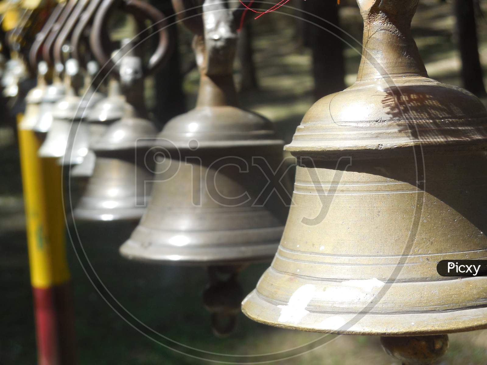 Metals ring bells outside the temple hanging on the pillar