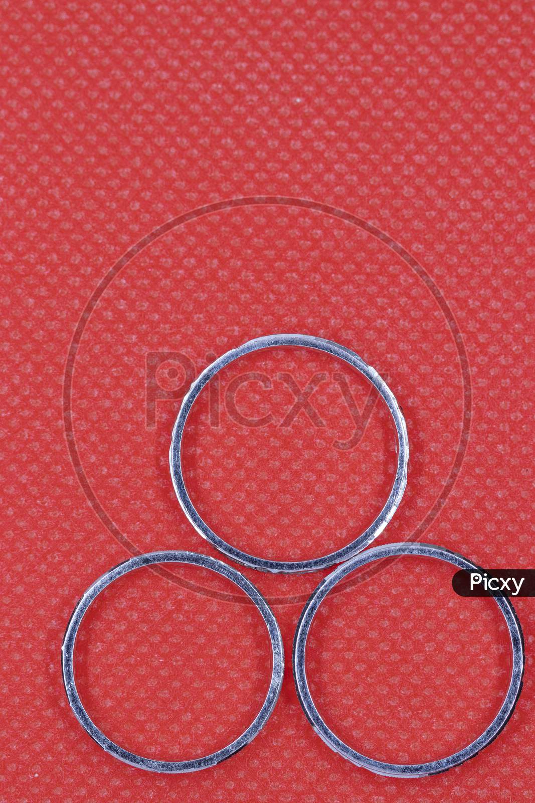 Silver Three Rings With Red Background