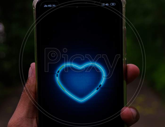 mobile with blue heart in hand image