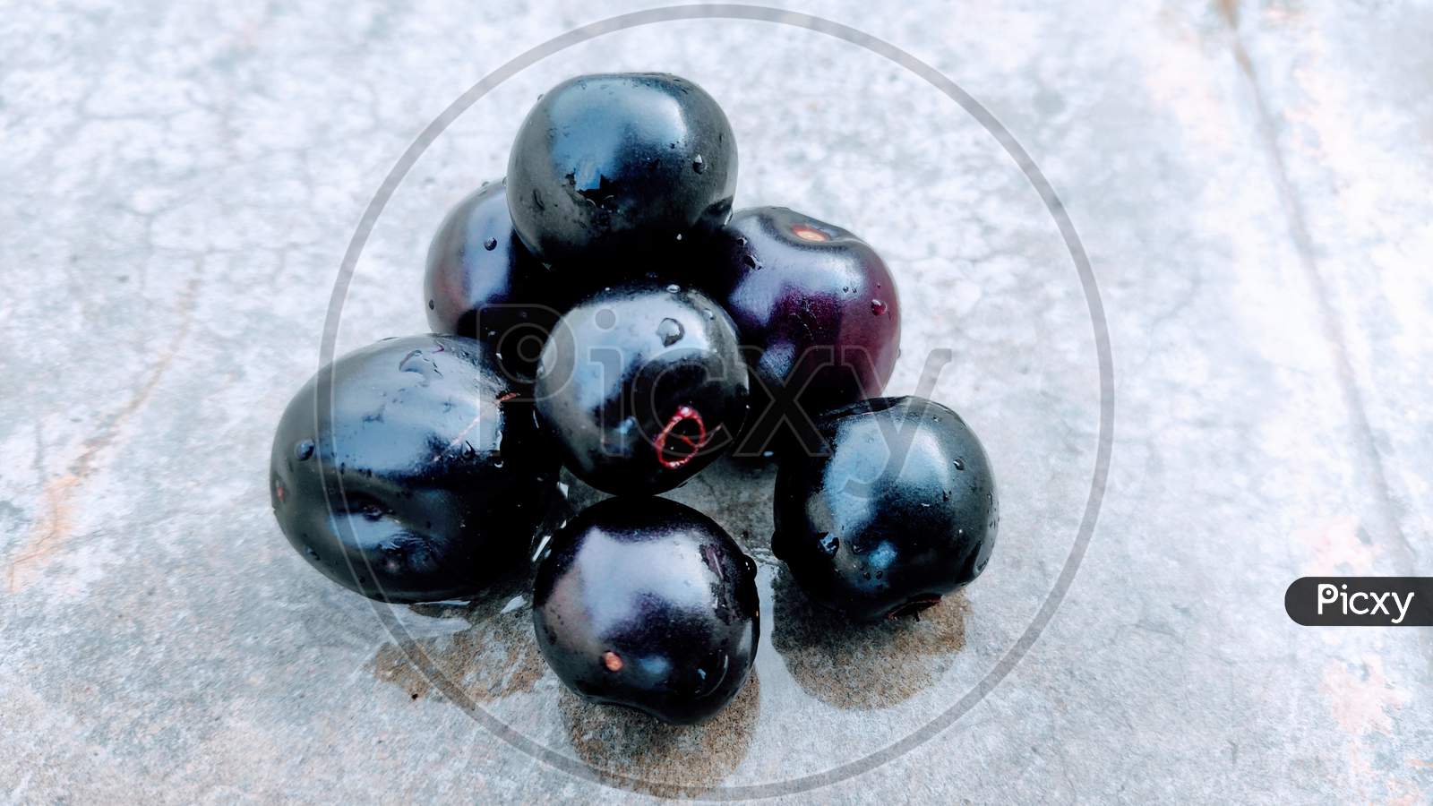 Fresh jamun fruits or Indian BlackBerry fruits on floor