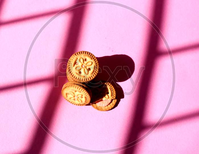 Top View Of Stacked Biscuits On Pink Isolated Background