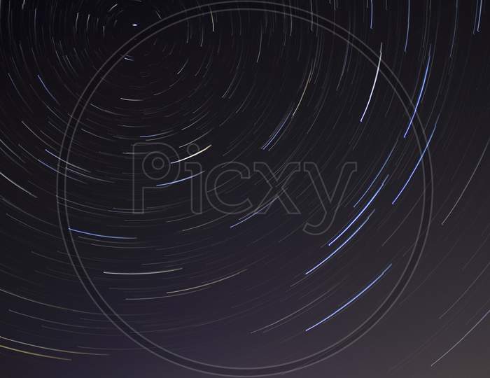 Landscape Photograph of Star Trails at Night Sky.