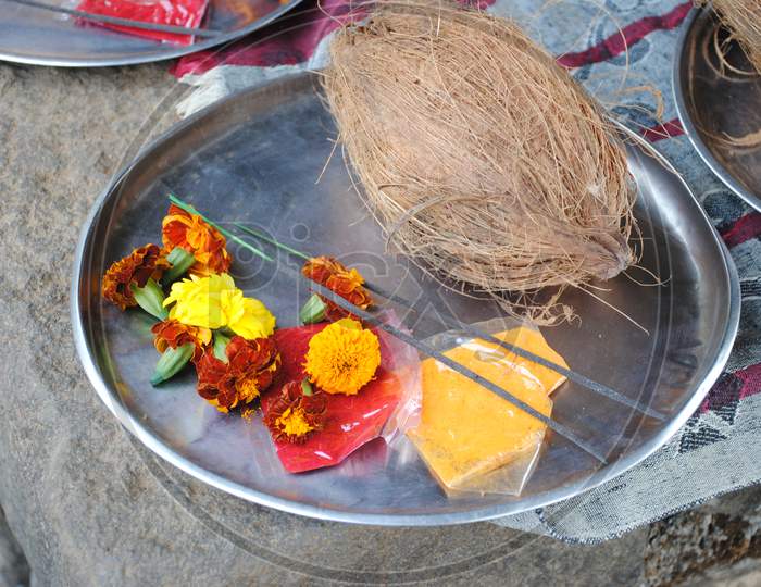 Puja thali with coconut , flowers and incense sticks