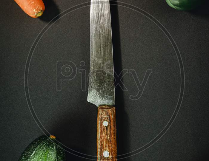 Long Chef Knife Surrounded By Vegetables