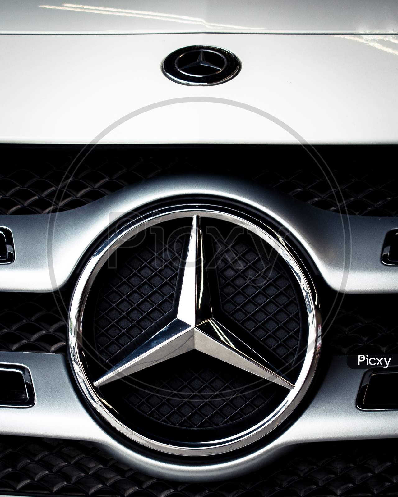 Glossy logo of Mercedes-Benz car