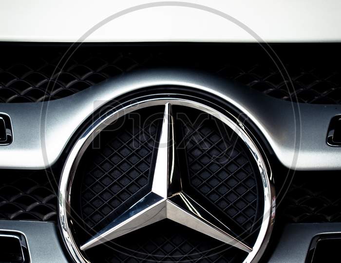 Glossy logo of Mercedes-Benz car