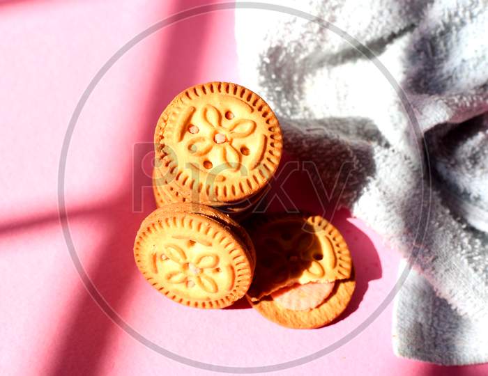 Top View Of Stacked Biscuits On Pink Isolated Background