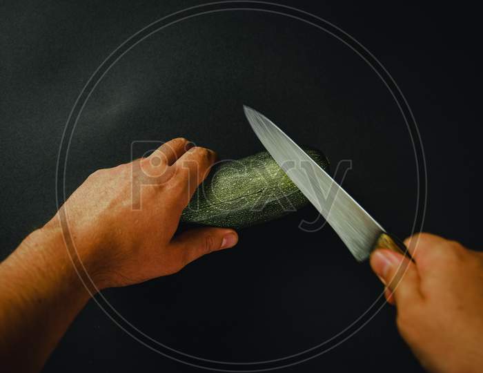 Cutting A Cucumber With A Long Knife 2