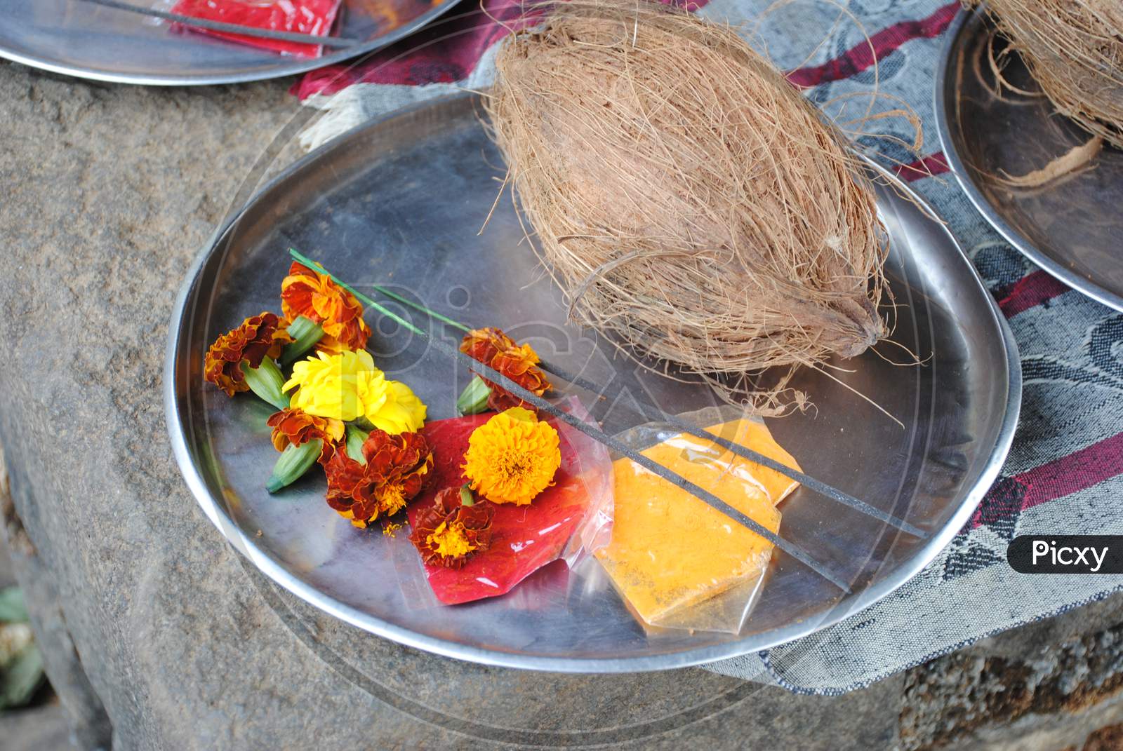 Puja thali with coconut , flowers and incense sticks