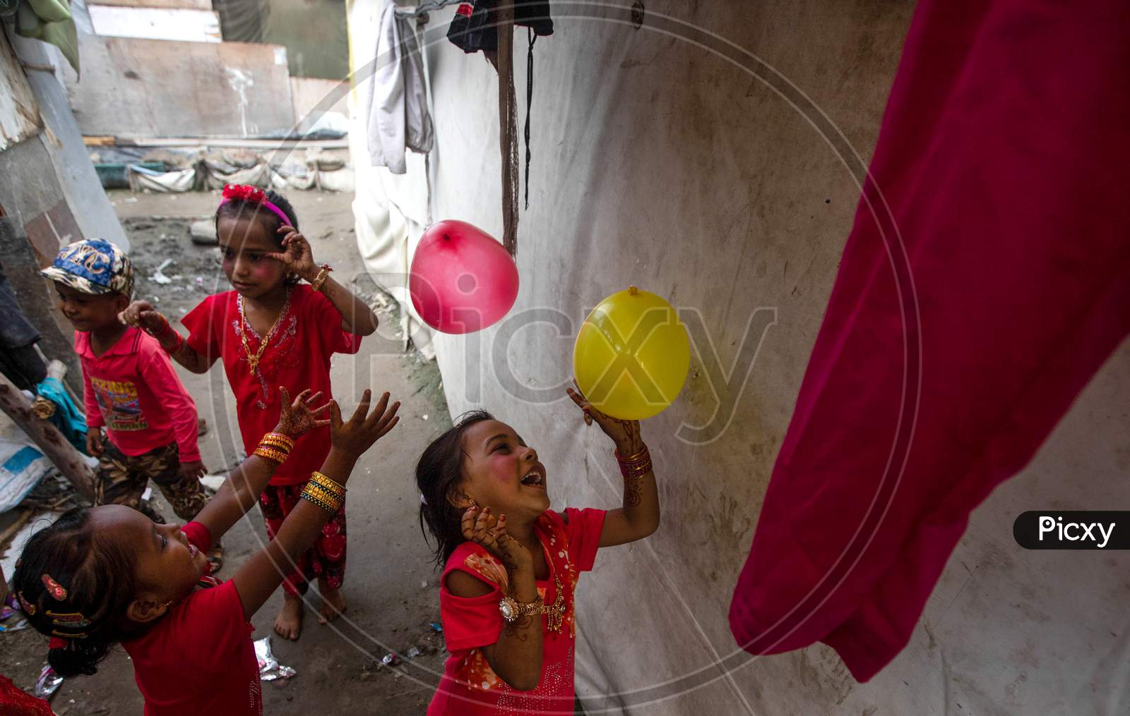 Rohingya refugee children play as they wear new clothes and make up during Eid Al-Adha (Feast of Sacrifice) festival at a camp in the outskirts of New Delhi, India on August 1, 2020.