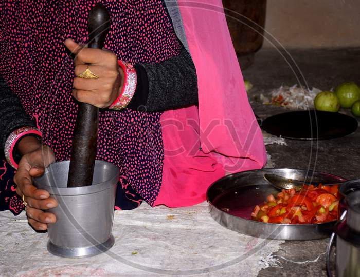 Indian Rural Woman Is Grinding Spices To Make Vegetable.