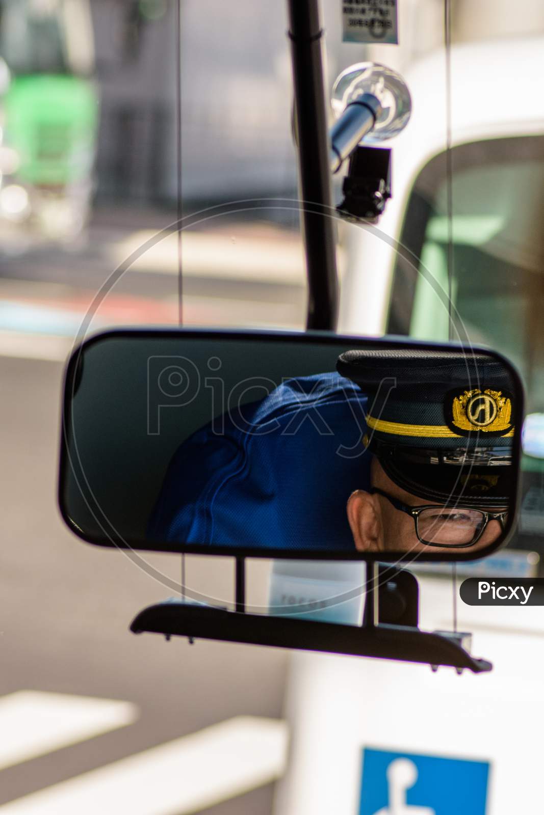 Bus Driver Taking A Look In The Rear View Mirror, Hiroshima, Japan