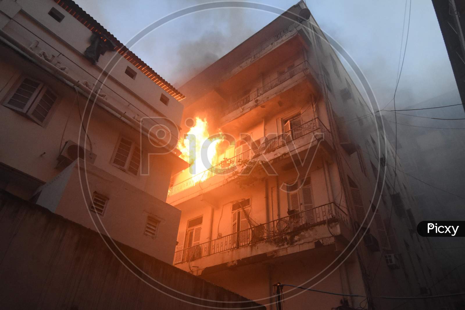 flames rise from a building after a massive fire broke out at multi storey building at pollock street in burrabazar area  on Monday 10th august 2020