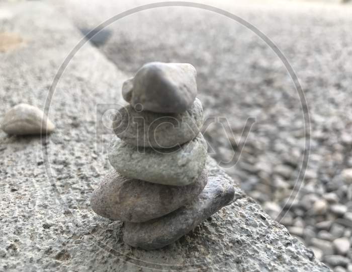 Smooth Surface Pebble Stones Are Stacked Above One Another Like An Art Background