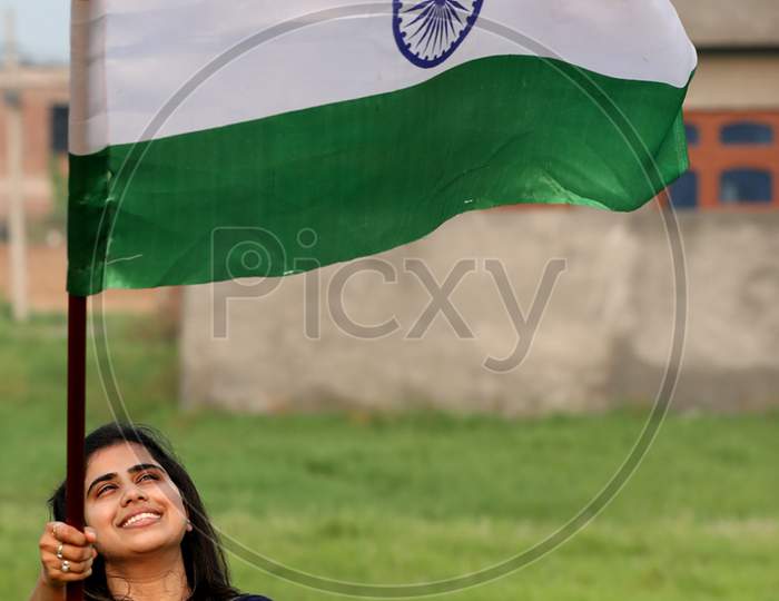 Girls hold the tricolor during rehearsals ahead of Independence Day at Jammu on August 10, 2020.
