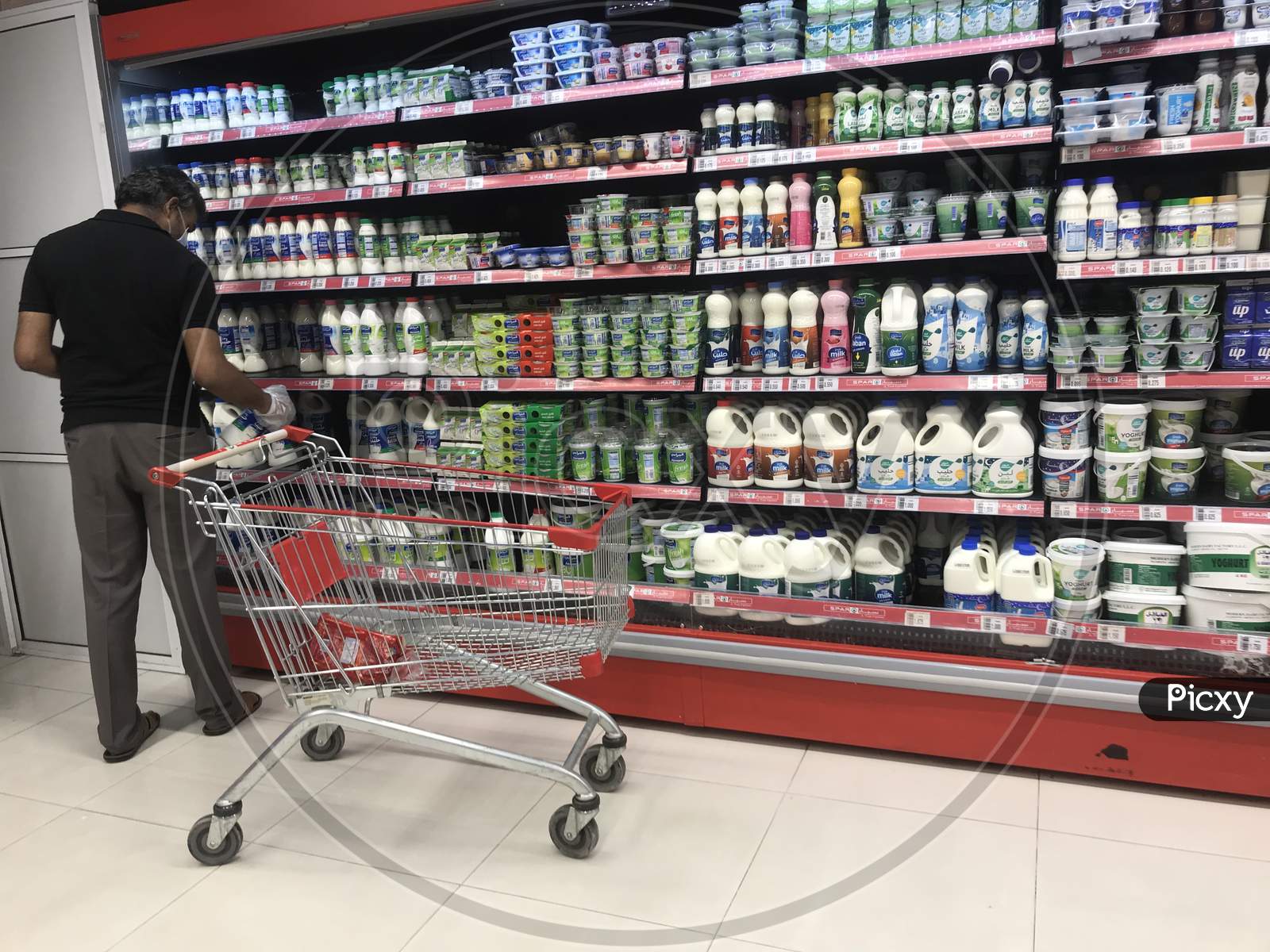 Man Wearing Face Mask Doing Shopping During Lock Down Due To Corona Virus Pandemic At Muscat