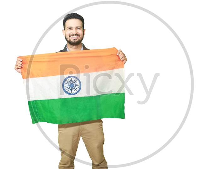 Happy Young Man Holding Indian National Tricolor Flag With Smile And Showing Patriotism, Republic Day Or Independence Day Concept Isolated On White Background Copy Space To Write Text.