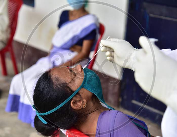 A Health Worker Takes A Nasal Swab Sample To Test For Covid-19  At Barhampur Village In Nagaon District Of Assam On August 8,2020.