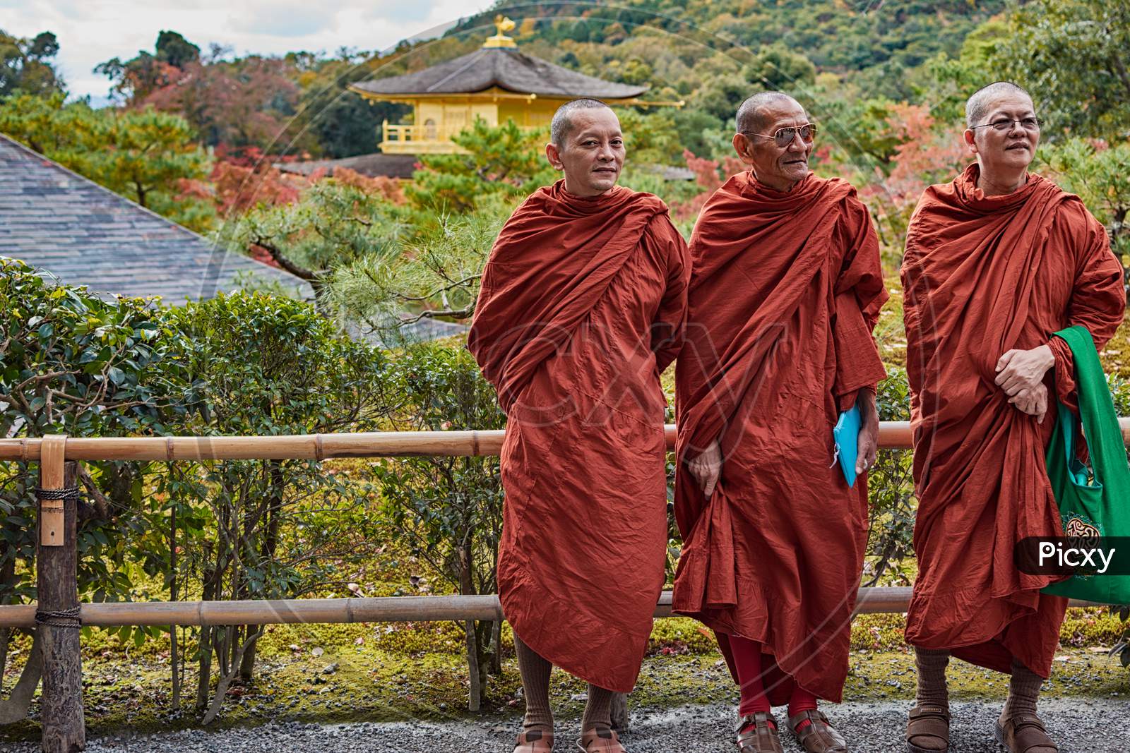Buddhist Monks Standing In Front Of Kinkakuji Temple Gooden Pavilion In Kyoto