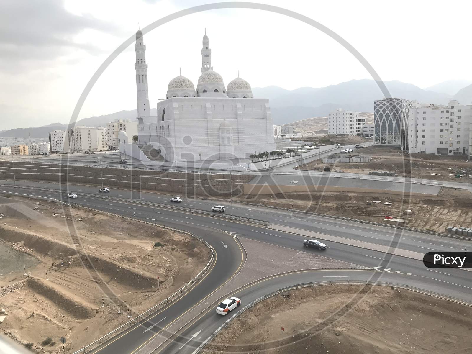Al Islamic Mosque Picture With The Background Of Muscat City With Cloudy Sky And Such A Beautiful View Of Cityscape