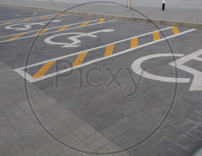 Tarmac Road With Allotted Handicapped Parking For Wheelchair Person