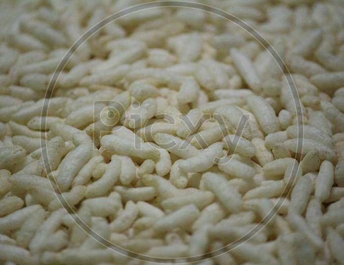 Close-Up Shot Of Lot Of Puffed Rice With White Background
