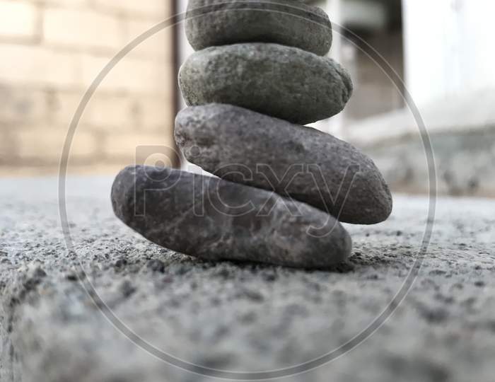 Smooth Surface Pebble Stones Are Stacked Above One Another Like An Art