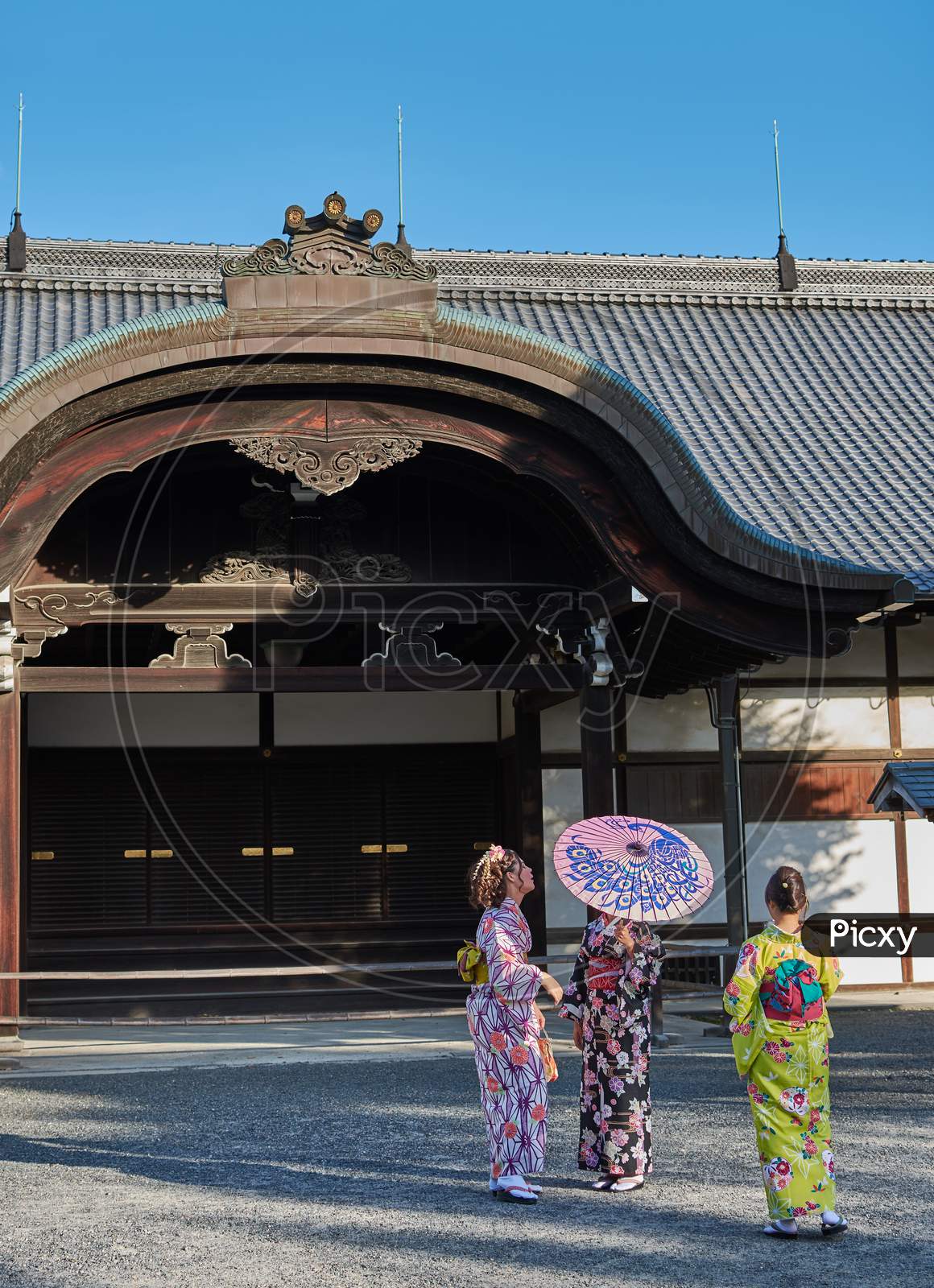 Girls In Traditional Japanese Kimonos At Nijo Castle In Kyoto, Japan