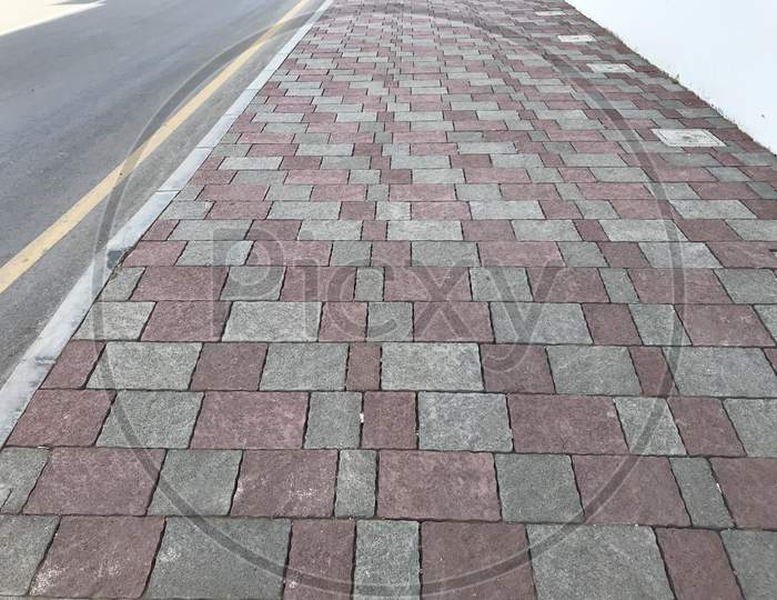 Interlock Tile Flooring And Protected By Kerb Precast Concrete Stones Before The Highways Or Roadways Infrastructure