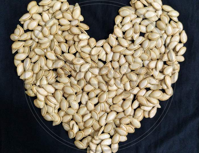 Beautiful pumpkin seeds heart shape arrangement.