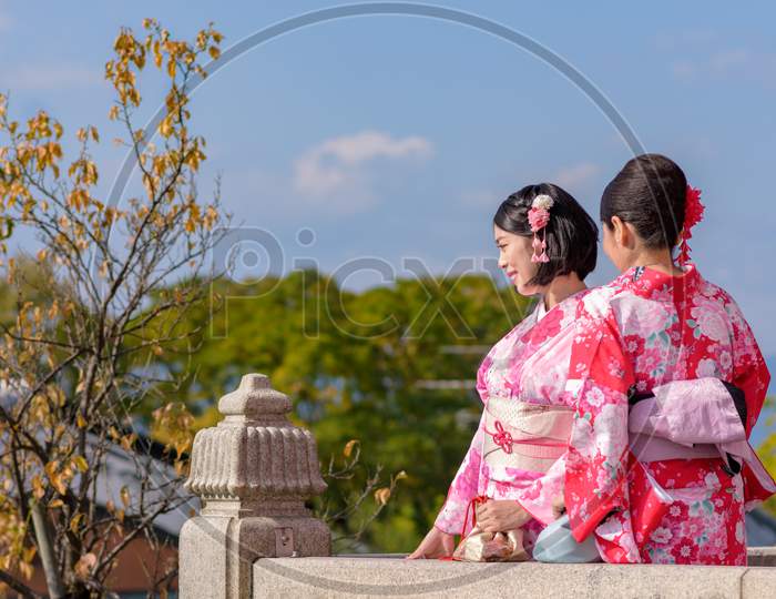 Japanese Girls Dressed In Kimonos At Kiyomizu-Dera Temple In Kyoto, Japan