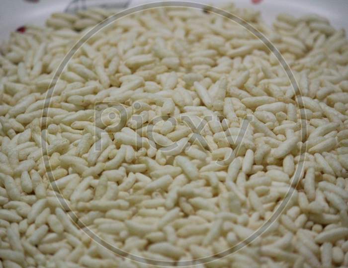 Close-Up Shot Of Lot Of Puffed Rice With White Background